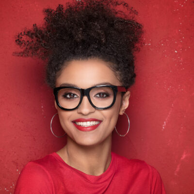 smiling beautiful african american young woman with afro wearing eyeglasses
