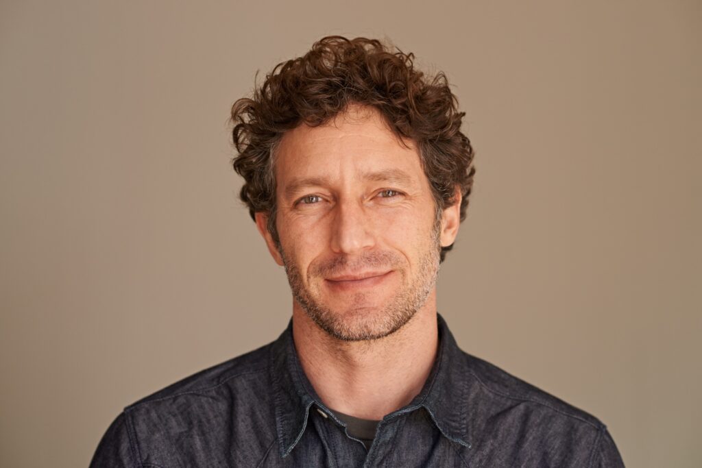 a handsome young man with curly hair