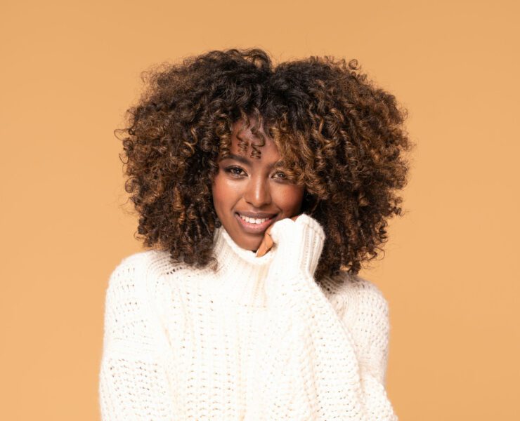 Afro girl in cozy fashionable sweater.