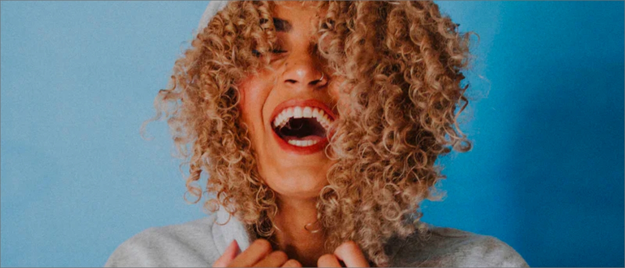 woman with big smile and blonde curls