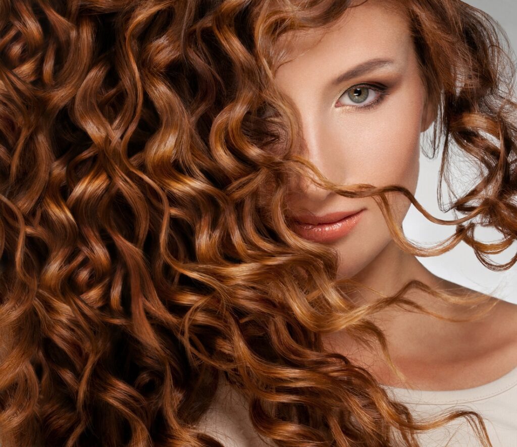 Beautiful young woman with long curly hair