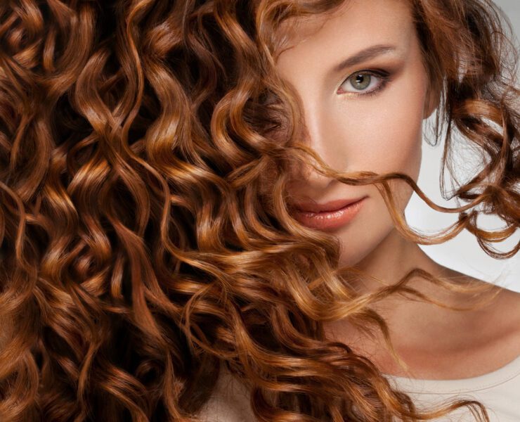 Beautiful young woman with long curly hair